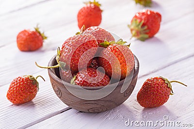 Fresh red strawberries with cream on the white wooden table. Stock Photo