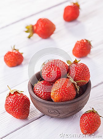 Fresh red strawberries with cream on the white wooden table. Stock Photo