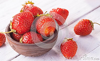 Fresh red strawberries with cream on the white wooden table. Stock Photo