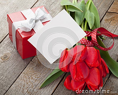 Fresh red tulips with gift box and greeting card Stock Photo