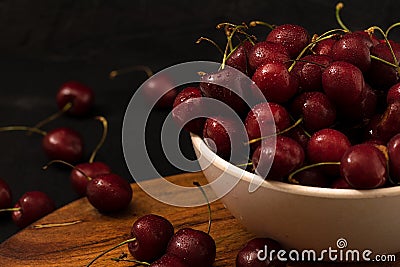 Fresh ripe cherries with water drops closeup dark photo Stock Photo