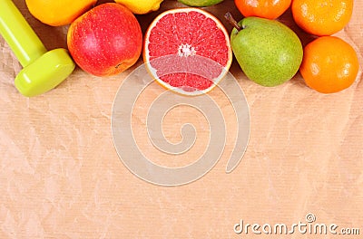 Fresh ripe fruits and dumbbells for fitness, concept of healthy lifestyles Stock Photo