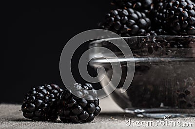 Fresh Ripe Juicy Blackberries in a plate on black background Stock Photo