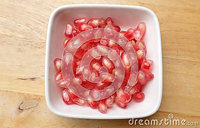 fresh ripe juicy grains Pomegranate, (Punica granatum) seeds in the square bowl Stock Photo