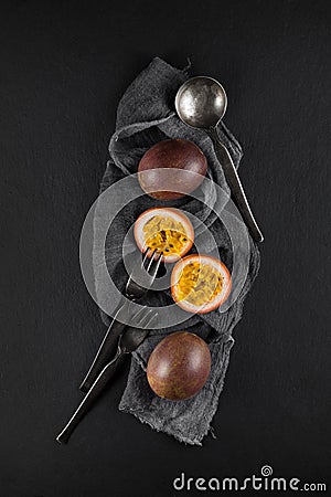 Fresh ripe passion fruit on a napkin and slate plate kitchen table Stock Photo