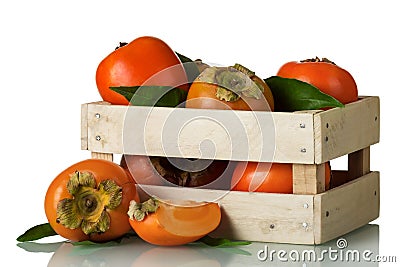 Fresh ripe persimmon in a wooden box and cut pieces isolated on white Stock Photo
