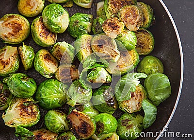 Fresh roasted Brussels sprouts in a black frying pan Stock Photo