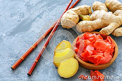 Fresh root, slices of pickled ginger and chopsticks. Stock Photo