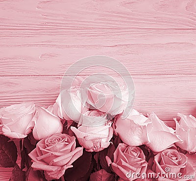 Fresh roses bouquet on wooden background border frame Stock Photo