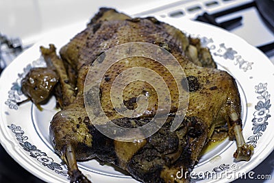 Fresh rosy duck baked in a sleeve lies on the dish Stock Photo