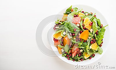 Fresh salad with fruits and greens on white wooden background top view with space for text Stock Photo