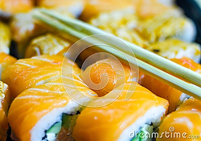 Fresh salmon philadelphia rolls. Smoked salmon rolls. Set of rolls on the board, table. One piece of roll. Food delivery, sushi. A Stock Photo