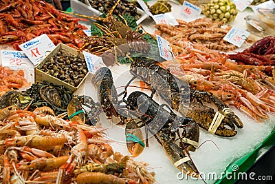 Fresh seafood stall at la Boqueria market in Barcelona, crayfish, prawns mussels Mediterranean cuisine Editorial Stock Photo