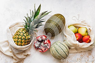 Fresh seasonal fruits in eco friendly and reusable shopping mesh bags Stock Photo