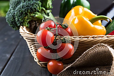 Fresh seasonal vegetables in basket on rustic wooden table Stock Photo