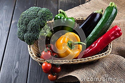 Fresh seasonal vegetables in basket on rustic wooden table Stock Photo