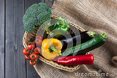 Fresh seasonal vegetables in basket on rustic wooden table Stock Photo