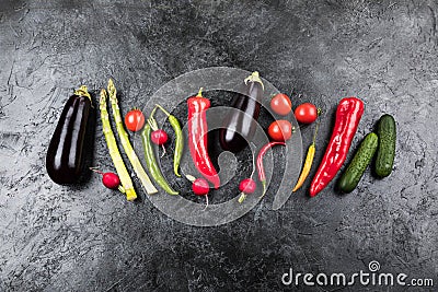 Fresh seasonal vegetables in row on black table top background Stock Photo