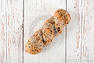 Fresh seedy bread on white wooden background Stock Photo