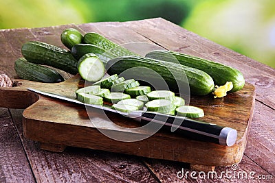 Fresh and sliced cucumbers. Sliced cucumbers on a cutting board. Stock Photo