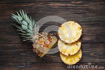Fresh sliced pineapple on a wood table. Top view Stock Photo