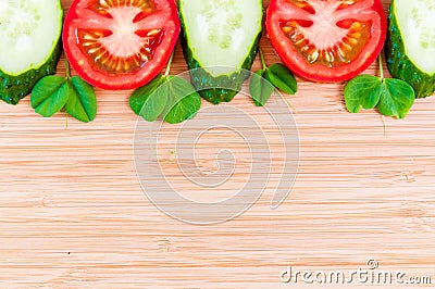 Fresh sliced vegetables on a wooden bamboo background Stock Photo