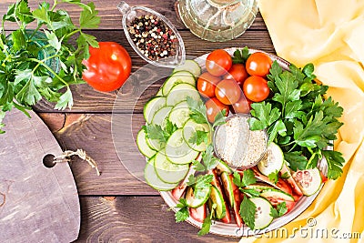 Fresh slices of cucumbers, tomatoes, sesame seeds in a bowl Stock Photo