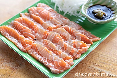 Fresh slices salmon fillet on plate to make Salmon Sashimi Stock Photo