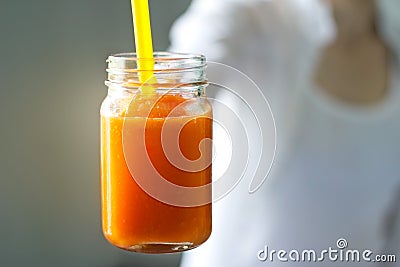 Fresh smoothie detox vegetable carrot in hand on vintage color tone style Stock Photo