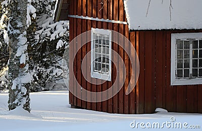 Fresh snow giving a mantle to a beautiful playhouse and trees in the garden Stock Photo