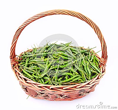 Fresh and spicy green chili peppers in rattan basket Stock Photo