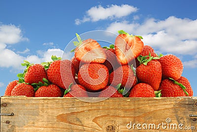 Fresh strawberries and a cut one Stock Photo