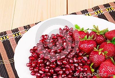 Fresh strawberries with pomegranate grains Stock Photo