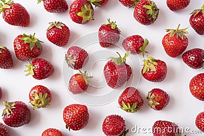 Fresh strawberries scattered on white background. Strawberries on a white background. Strawberry on white background. Creative fre Stock Photo
