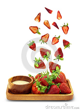 Fresh strawberries springing up from a wooden plate isolated on white background,Object have clipping path. Stock Photo