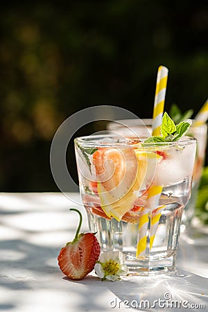 Fresh strawberry cocktail. Fresh summer cocktail with strawberry and ice cubes. Glass of strawberry soda drink on dark Stock Photo