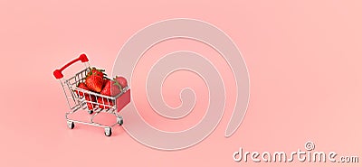 Fresh strawberry in shopping card on pink background. Online shopping and Valentines Day minimalistic concept. Stock Photo