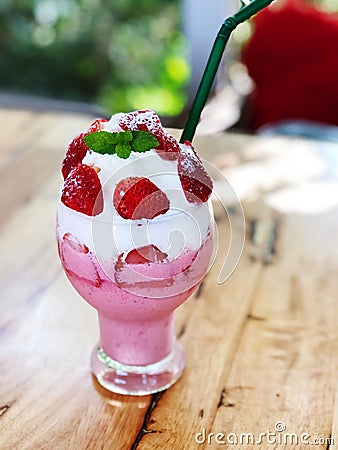 Fresh strawberry smoothie in glass whipped cream and mint leaf on top Stock Photo