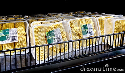 Fresh succulent mini corn cobs cobbettes packaged in plastic containers Editorial Stock Photo