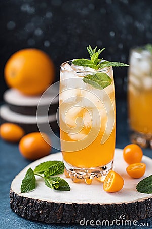 Fresh summer cocktail with orange juice and ice cubes. Glass of orange soda drink on dark background Stock Photo