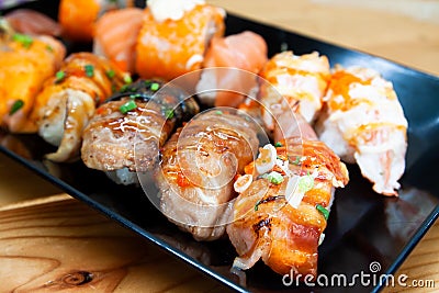 Fresh sushi rolls on black plate, Healthy and delicious traditional Asian menu Stock Photo