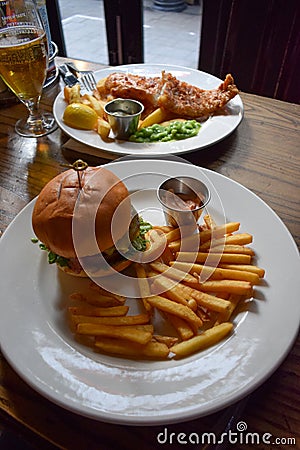 Fresh and tasty beef burger and British Traditional Fish and chips Stock Photo