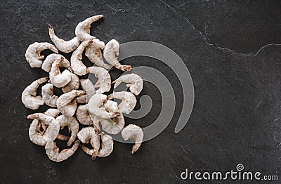 Fresh tiger shrimps or prawn with ice on slate stone background. Seafood, top view Stock Photo