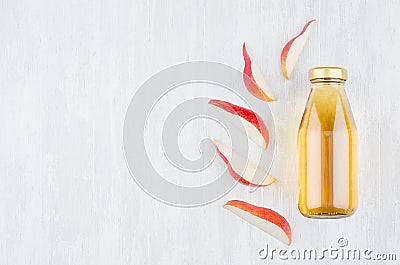 Fresh transparent yellow pear juice in glass bottle with sliced fruit as mock up for advertising, portfolio, design top view. Stock Photo