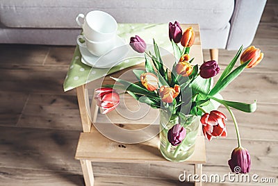 Fresh tulips in vase cozy home spring decoration Stock Photo