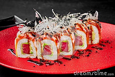 Fresh tuna and avocado sushi rolls with salmon, crab and masago Stock Photo