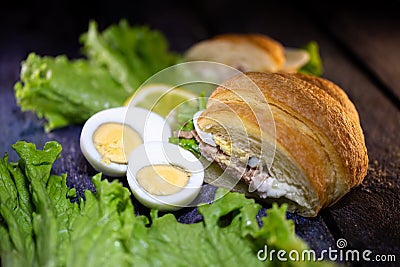 fresh tuna croissant lettuce leaf and egg Stock Photo
