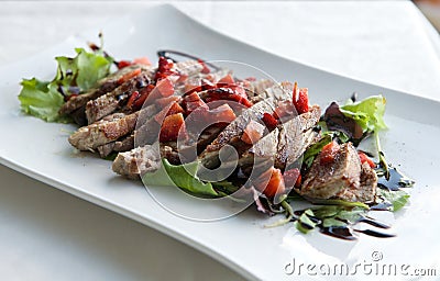 Fresh tuna with strawberries in grey light background, sicialiian food, italian food, fish in plate, fresh tuna, italian kitchen Stock Photo
