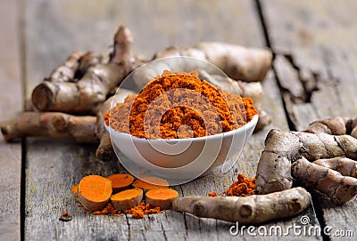 Fresh turmeric roots on wooden table Stock Photo