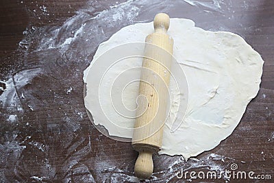 Fresh unbaked dough with rolling pin Stock Photo